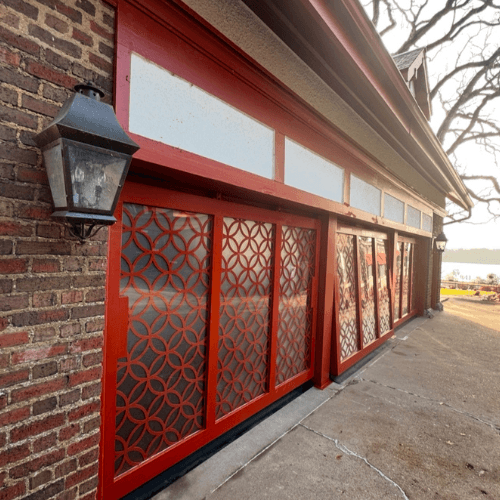 Triple PowerLift Doors with Ornamental Iron Mastery